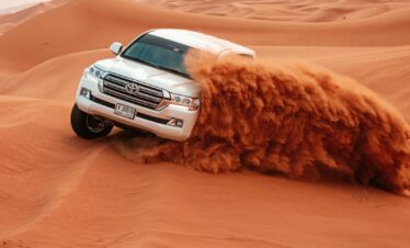 Evening Desert Safari in Dubai with camel rides, dune bashing, and BBQ dinner under the stars