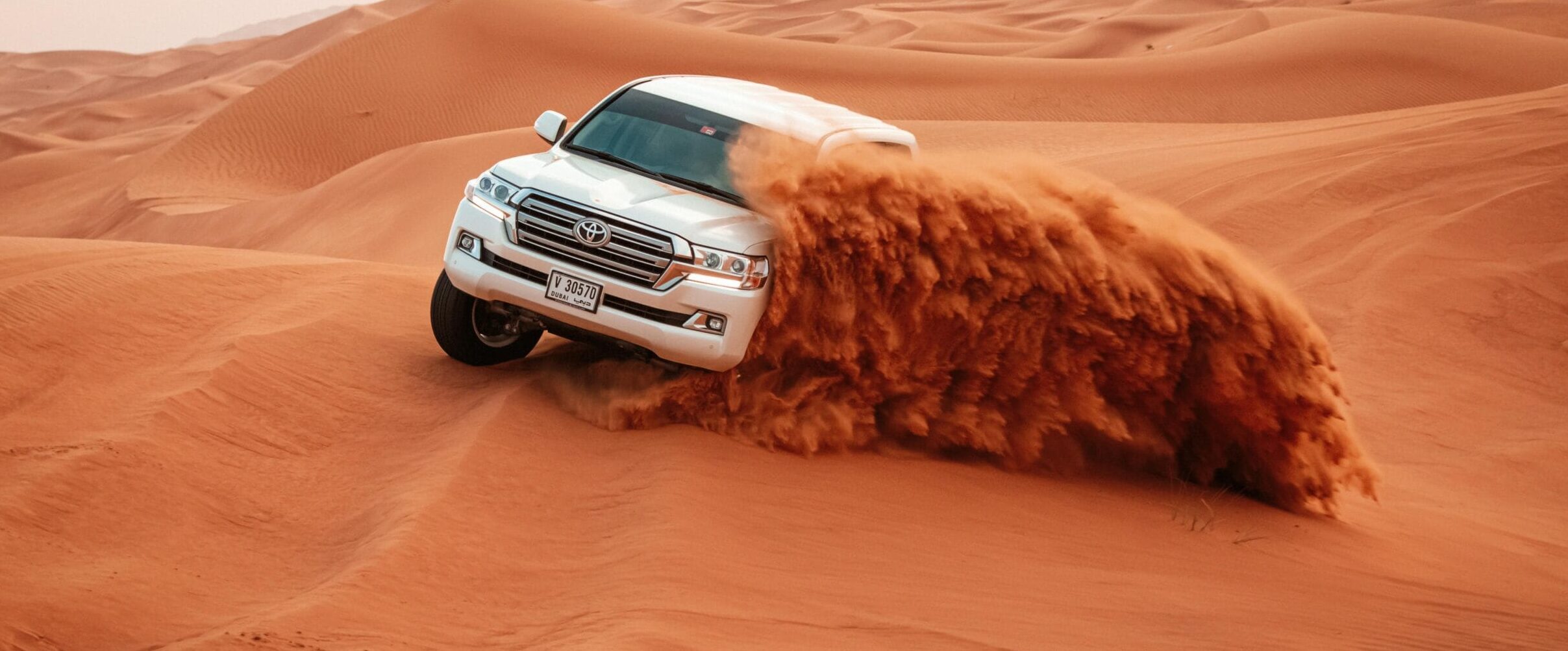 Evening Desert Safari in Dubai with camel rides, dune bashing, and BBQ dinner under the stars