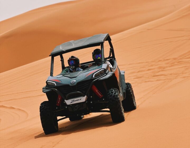 Desert dune buggy adventure with riders enjoying a thrilling off-road tour in Dubai’s desert