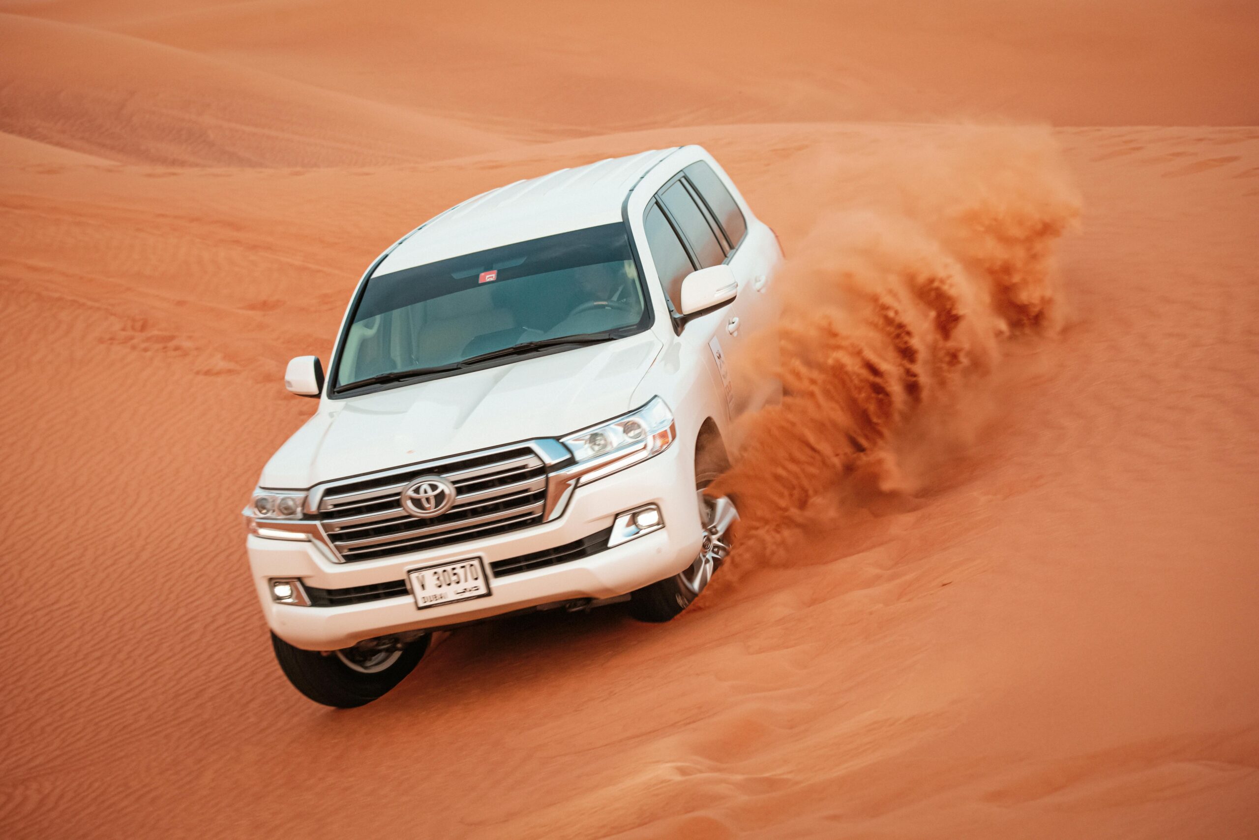 Morning desert safari in Dubai with golden dunes, dune bashing, and camel riding under early sunlight